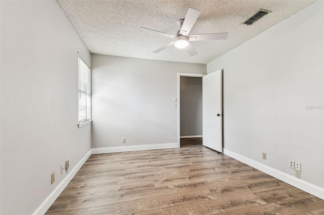 39650 US Highway 19 N Unit 143, Tarpon Springs, FL 34689 - unfurnished room featuring ceiling fan, a textured ceiling, wood finished floors, and baseboards