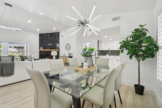 14170 Fennsbury Dr, Tampa, FL 33624 - dining room featuring light wood-style floors, recessed lighting, a chandelier, and high vaulted ceiling
