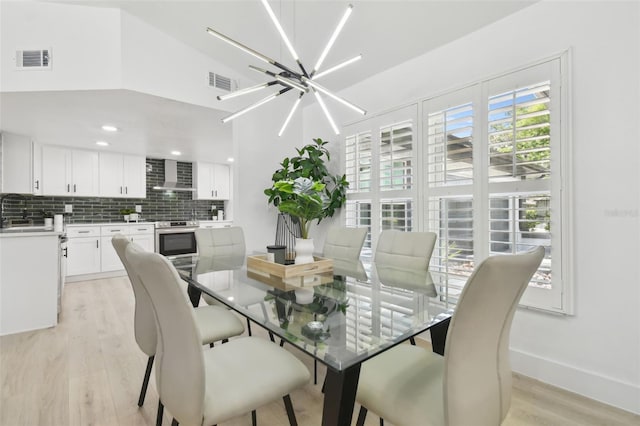 14170 Fennsbury Dr, Tampa, FL 33624 - dining space with a chandelier, light wood-style flooring, and baseboards