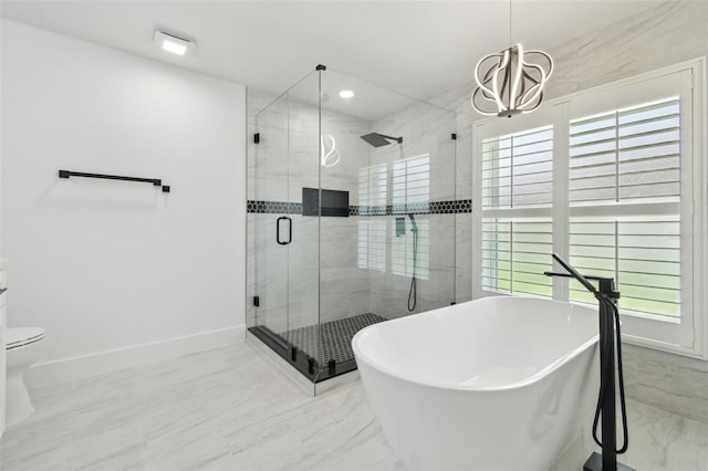 14170 Fennsbury Dr, Tampa, FL 33624 - full bath with a soaking tub, a shower stall, a chandelier, marble finish flooring, and toilet