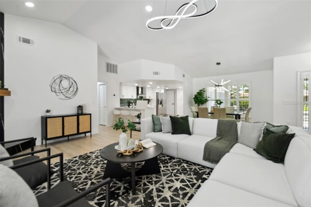 14170 Fennsbury Dr, Tampa, FL 33624 - living area featuring a chandelier, light wood-style floors, and high vaulted ceiling