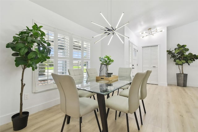 14170 Fennsbury Dr, Tampa, FL 33624 - dining room featuring light wood finished floors, baseboards, and a chandelier