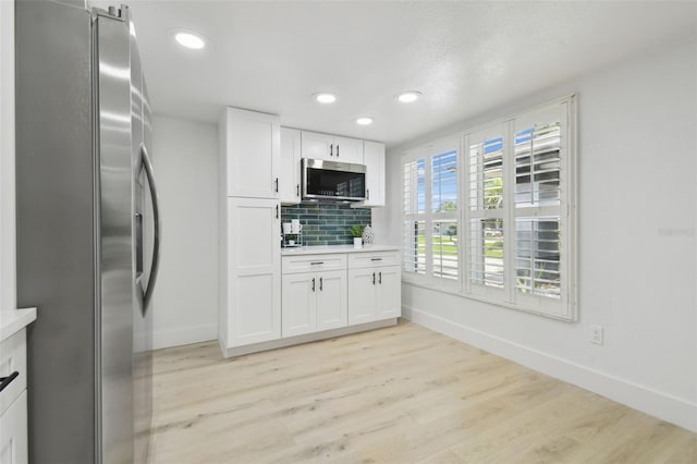 14170 Fennsbury Dr, Tampa, FL 33624 - kitchen with stainless steel appliances, baseboards, light wood-style floors, and recessed lighting