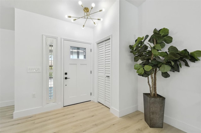 14170 Fennsbury Dr, Tampa, FL 33624 - entryway with a chandelier, wood finished floors, and baseboards