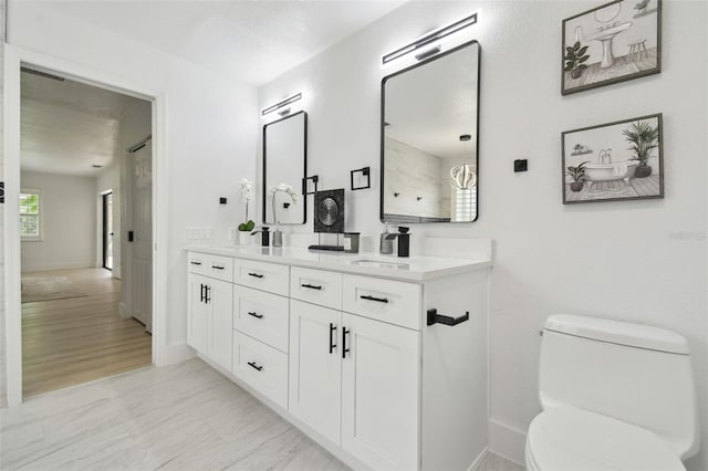 14170 Fennsbury Dr, Tampa, FL 33624 - full bath featuring double vanity, toilet, and baseboards