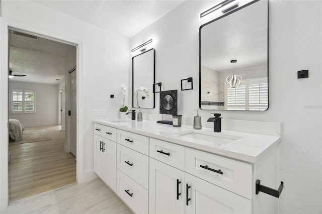 14170 Fennsbury Dr, Tampa, FL 33624 - ensuite bathroom with double vanity and baseboards
