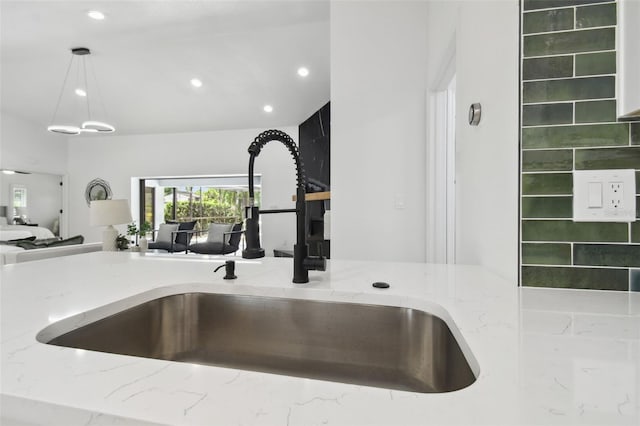 14170 Fennsbury Dr, Tampa, FL 33624 - kitchen view of a sink, light stone counters, recessed lighting, and hanging light fixtures