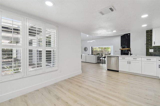 14170 Fennsbury Dr, Tampa, FL 33624 - kitchen featuring stainless steel dishwasher, white cabinets, recessed lighting, light wood-style floors, and baseboards