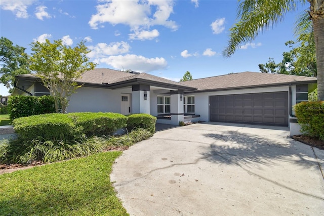 14170 Fennsbury Dr, Tampa, FL 33624 - view of front of house with a garage, stucco siding, and concrete driveway