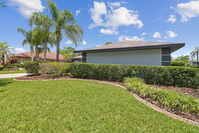 14170 Fennsbury Dr, Tampa, FL 33624 - view of property exterior with a yard and stucco siding