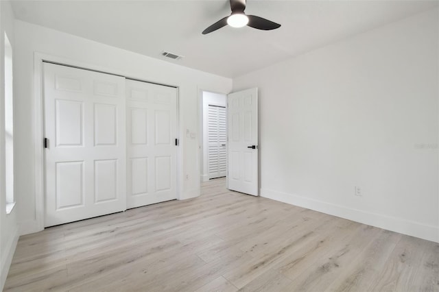 14170 Fennsbury Dr, Tampa, FL 33624 - unfurnished bedroom with light wood-type flooring, baseboards, a closet, and a ceiling fan