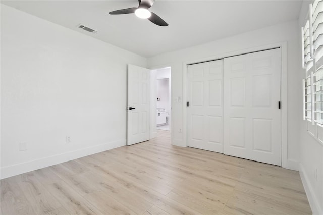 14170 Fennsbury Dr, Tampa, FL 33624 - unfurnished bedroom with light wood-style floors, baseboards, a closet, and a ceiling fan
