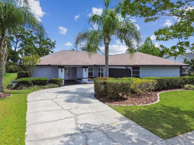 14170 Fennsbury Dr, Tampa, FL 33624 - ranch-style house with a front lawn, stucco siding, and driveway