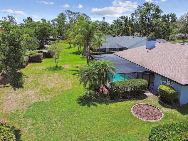 14170 Fennsbury Dr, Tampa, FL 33624 - view of grassy yard with a lanai, an outdoor pool, and view of wooded area