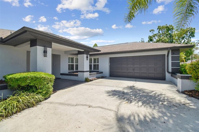 14170 Fennsbury Dr, Tampa, FL 33624 - ranch-style house with a garage, driveway, and stucco siding
