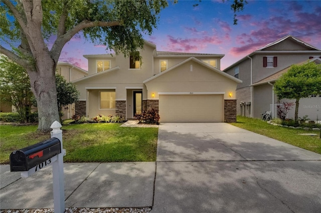 view of front of property with a garage, a front yard, stone siding, and driveway