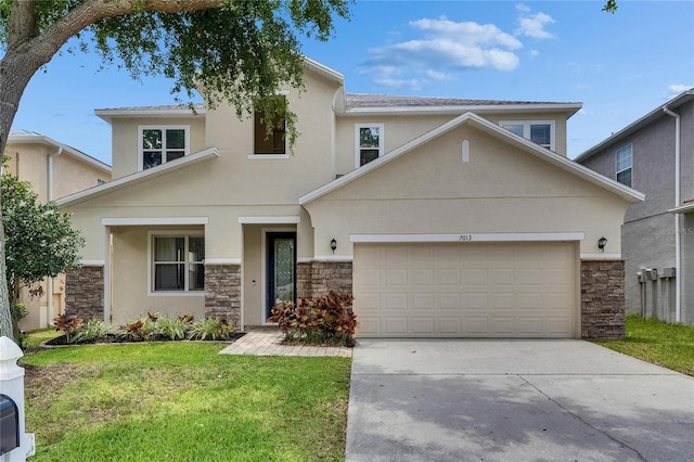 view of front of home featuring stone siding, stucco siding, a front lawn, and concrete driveway