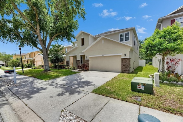 traditional home with stucco siding, concrete driveway, a front lawn, and stone siding