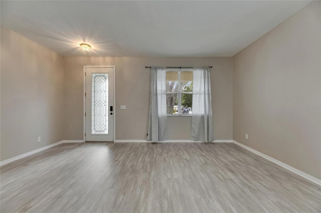 entryway with baseboards and light wood-type flooring