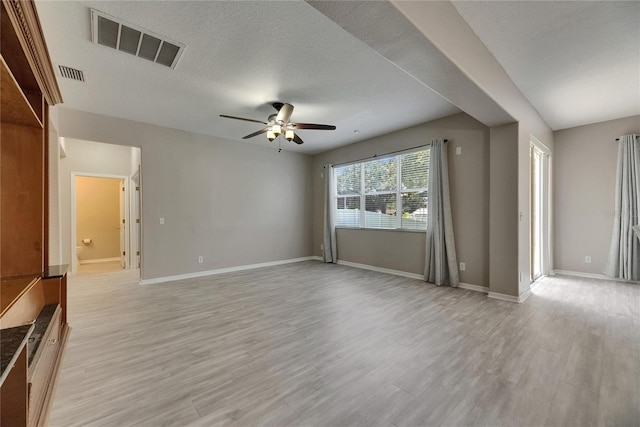 unfurnished living room featuring a ceiling fan, light wood-style floors, and baseboards
