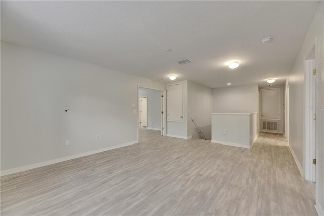 unfurnished room featuring light wood-style floors and baseboards