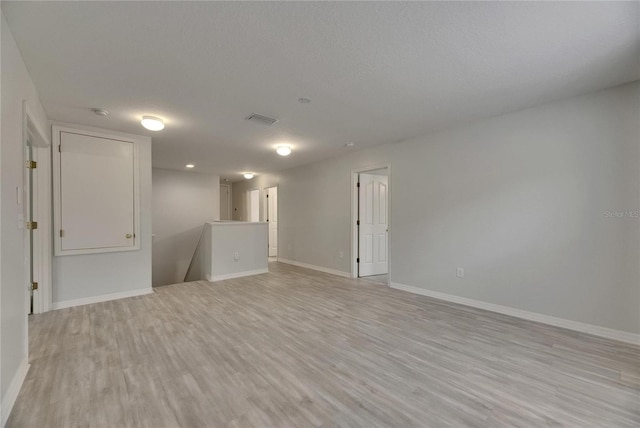 unfurnished room featuring light wood-style floors and baseboards