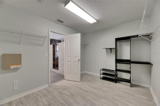 walk in closet featuring wood finished floors
