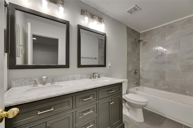bathroom with shower / washtub combination, toilet, double vanity, and tile patterned floors
