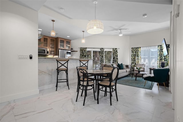 1010 Central Ave Unit 227, Saint Petersburg, FL 33705 - dining space featuring light marble finish flooring, ceiling fan, and baseboards