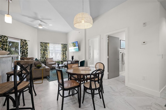 1010 Central Ave Unit 227, Saint Petersburg, FL 33705 - dining room featuring light marble finish flooring, ceiling fan, and baseboards