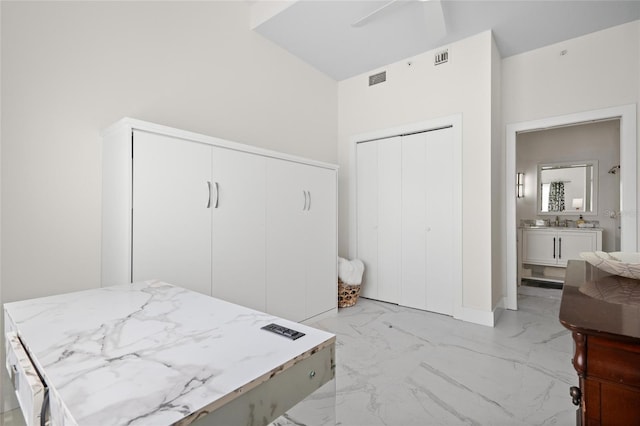1010 Central Ave Unit 227, Saint Petersburg, FL 33705 - bedroom with light marble finish flooring and ensuite bathroom