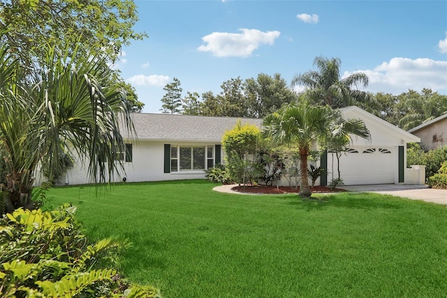 71 Flamingo Cir, Safety Harbor, FL 34695 - view of front facade with concrete driveway, a garage, and a front lawn
