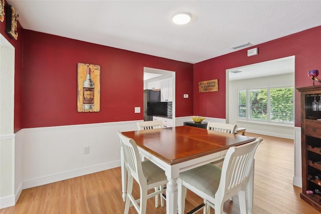 71 Flamingo Cir, Safety Harbor, FL 34695 - dining area featuring light wood-type flooring and wainscoting