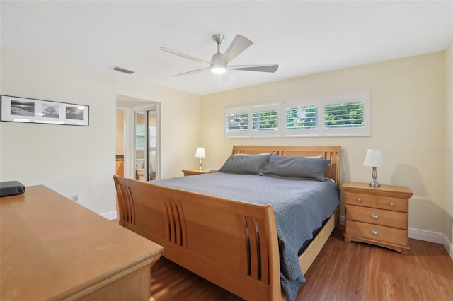 71 Flamingo Cir, Safety Harbor, FL 34695 - bedroom with wood finished floors, multiple windows, baseboards, and a ceiling fan