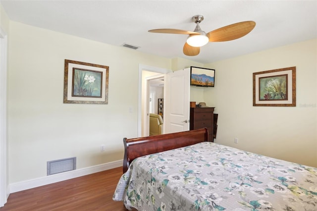 71 Flamingo Cir, Safety Harbor, FL 34695 - bedroom featuring wood finished floors, baseboards, and a ceiling fan