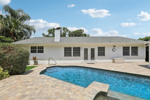 71 Flamingo Cir, Safety Harbor, FL 34695 - swimming pool with french doors and a patio