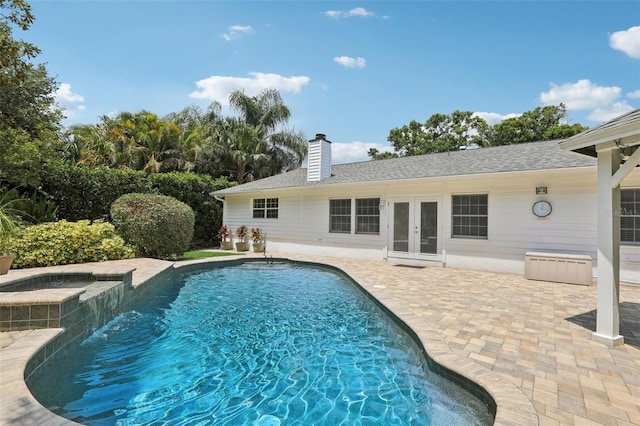 71 Flamingo Cir, Safety Harbor, FL 34695 - swimming pool featuring french doors, an in-ground hot tub, and a patio