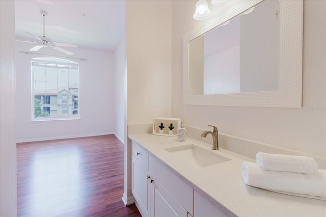 18107 Peregrines Perch Pl Unit 6303, Lutz, FL 33558 - bathroom with wood finished floors, vanity, ceiling fan, and baseboards