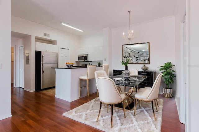 18107 Peregrines Perch Pl Unit 6303, Lutz, FL 33558 - dining area with dark wood-style flooring, a chandelier, and baseboards