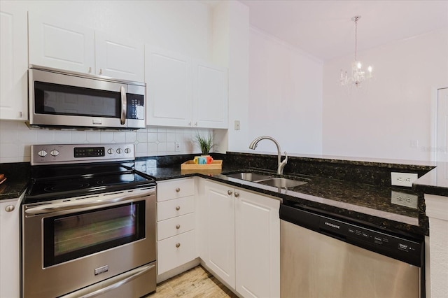 18107 Peregrines Perch Pl Unit 6303, Lutz, FL 33558 - kitchen featuring appliances with stainless steel finishes, a sink, a chandelier, white cabinetry, and a peninsula
