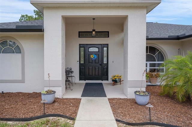 1854 S Overview Dr, Lecanto, FL 34461 - doorway to property with roof with shingles and stucco siding