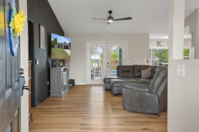 1854 S Overview Dr, Lecanto, FL 34461 - living area with light wood-style flooring, ceiling fan, french doors, a fireplace, and baseboards
