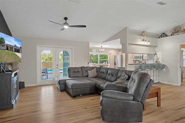 1854 S Overview Dr, Lecanto, FL 34461 - living room featuring lofted ceiling, light wood-style flooring, ceiling fan, french doors, and baseboards