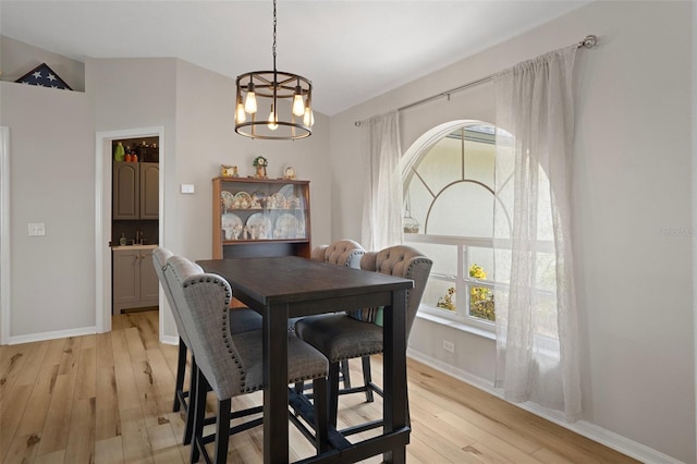 1854 S Overview Dr, Lecanto, FL 34461 - dining area featuring a chandelier, light wood-type flooring, vaulted ceiling, and baseboards