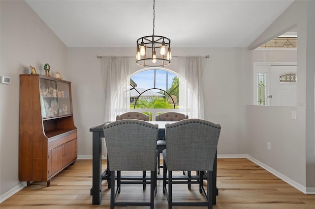 1854 S Overview Dr, Lecanto, FL 34461 - dining room featuring a chandelier, healthy amount of natural light, light wood-type flooring, and baseboards