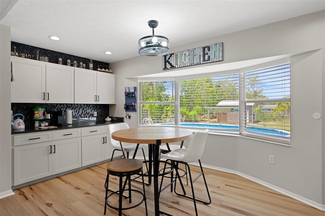 1854 S Overview Dr, Lecanto, FL 34461 - kitchen featuring tasteful backsplash, healthy amount of natural light, baseboards, light wood-type flooring, and recessed lighting