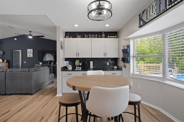 1854 S Overview Dr, Lecanto, FL 34461 - kitchen with ceiling fan, decorative backsplash, light wood-style floors, white cabinets, and dark countertops