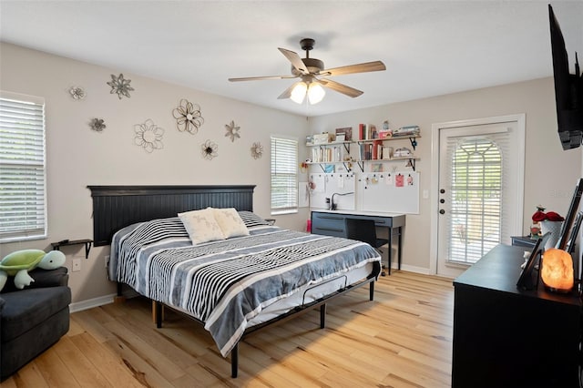 1854 S Overview Dr, Lecanto, FL 34461 - bedroom featuring light wood-style floors, access to exterior, a ceiling fan, and baseboards