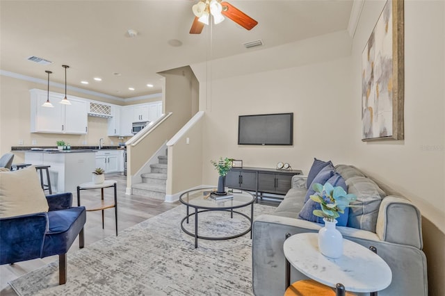 215 S Westland Ave Unit 3, Tampa, FL 33606 - living room with a ceiling fan, light wood-style floors, stairs, ornamental molding, and baseboards