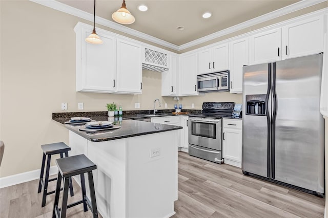 215 S Westland Ave Unit 3, Tampa, FL 33606 - kitchen with stainless steel appliances, a sink, white cabinetry, ornamental molding, and a peninsula